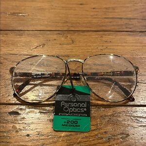 Personal Optics Gold Frame Glasses +200 medium with spring hinges for comfort.